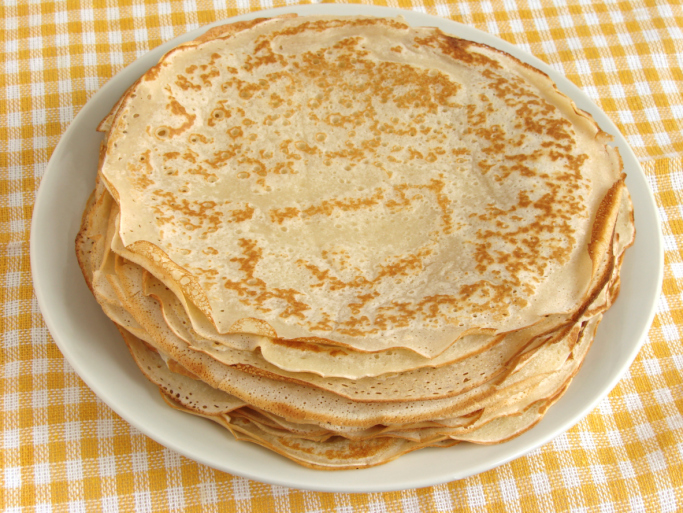pancakes pile on yellow checker tablecloth